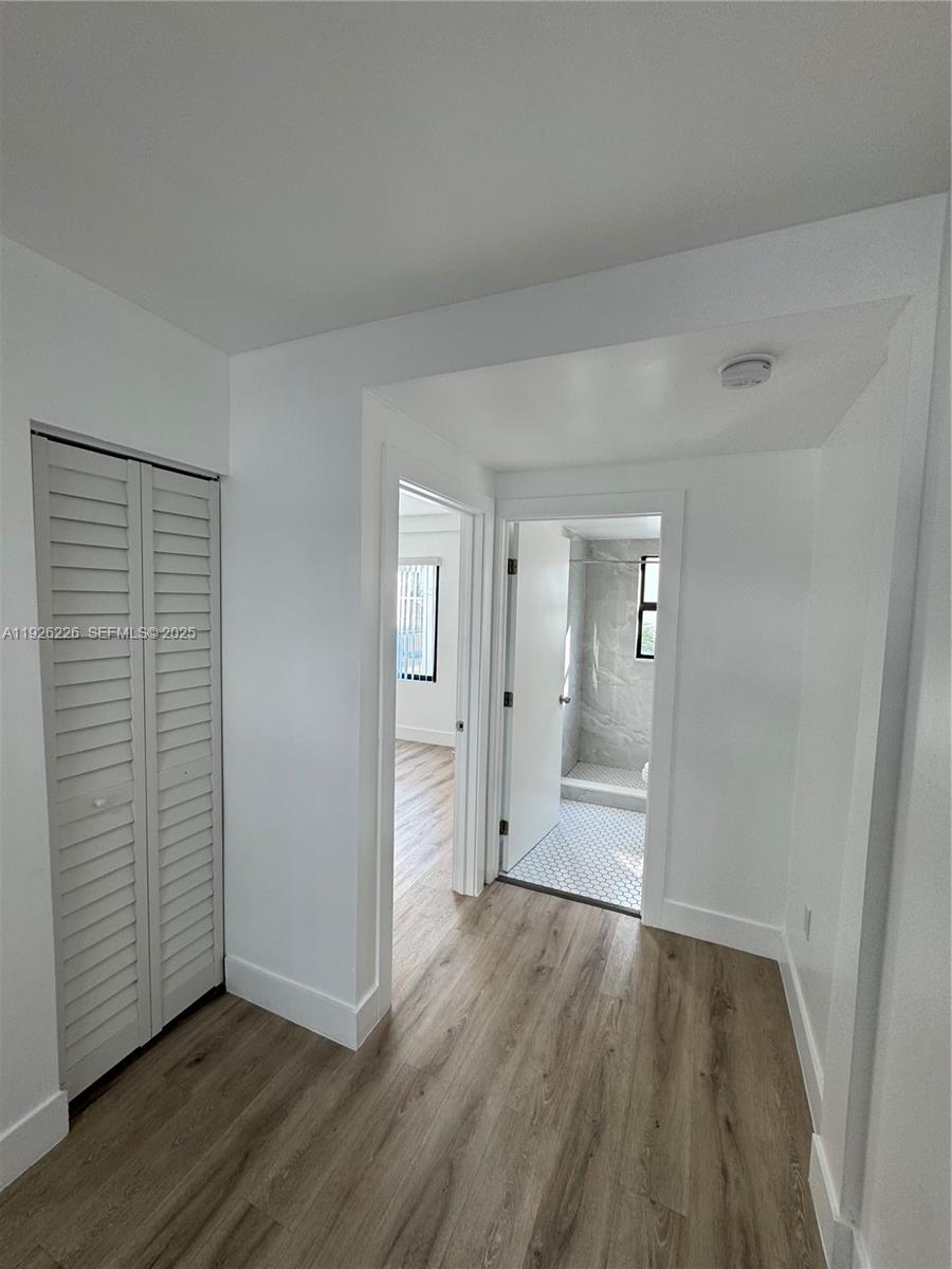 1969 Northwest 2nd Court, Unit 6 Miami, FL 33136 - Photo 9 of 17 wooden floor in an empty room