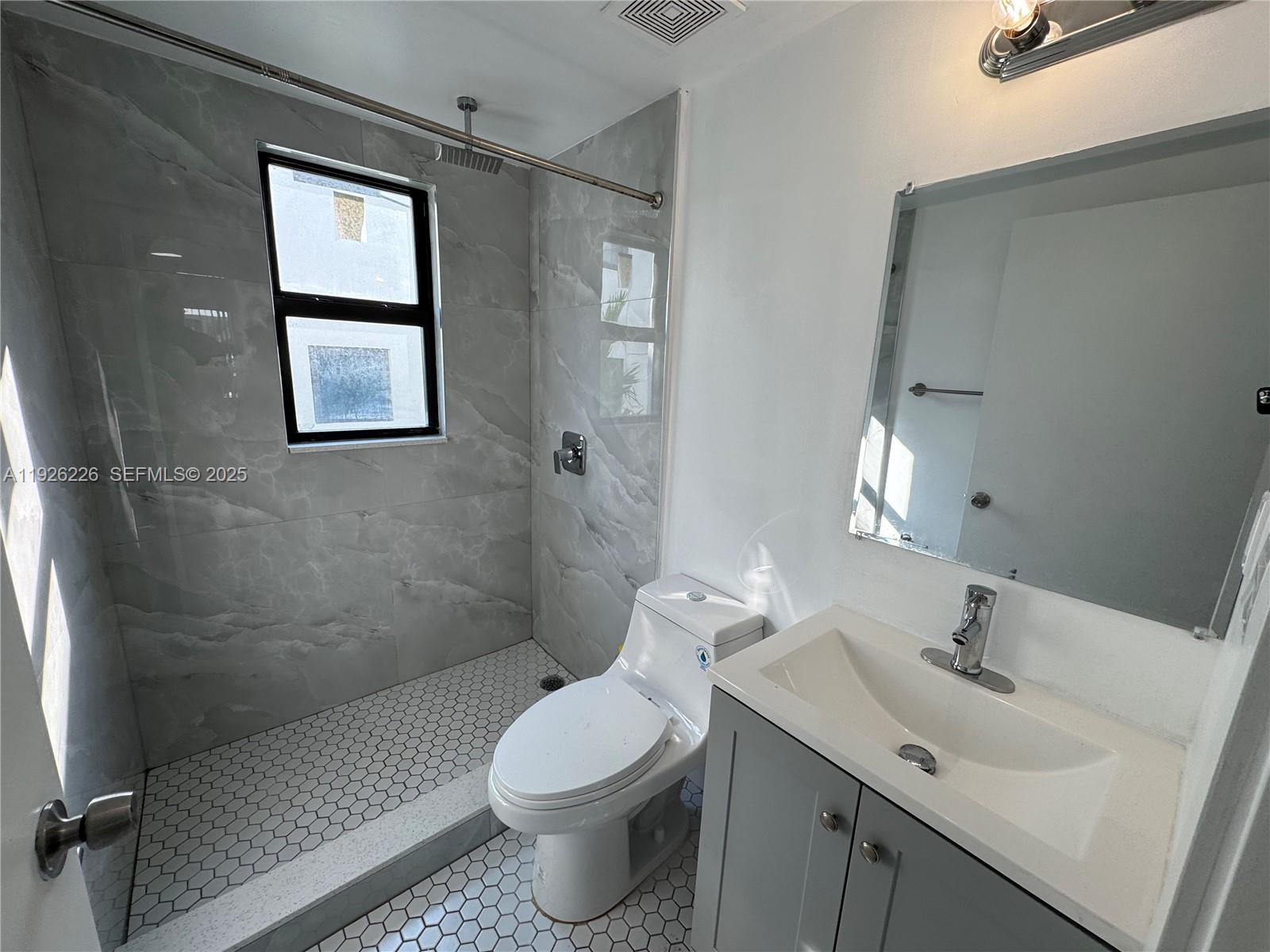 1969 Northwest 2nd Court, Unit 6 Miami, FL 33136 - Photo 10 of 17 a bathroom with a sink toilet and shower