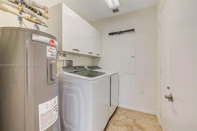 a kitchen with refrigerator and cabinets