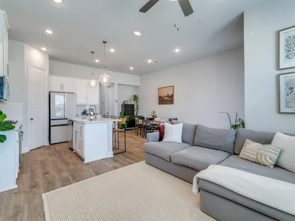 a living room with furniture and kitchen view