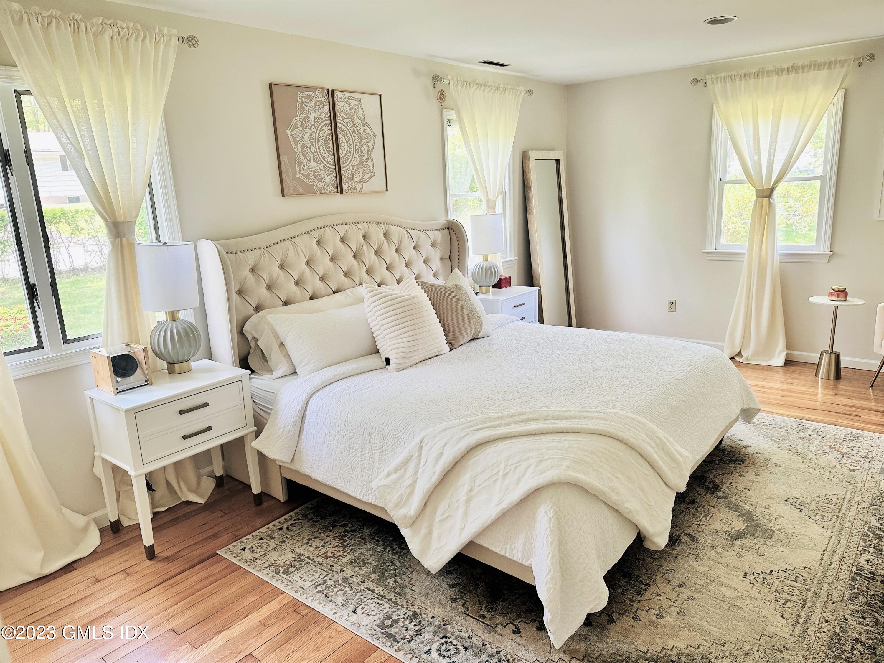 36 Morningside Drive Greenwich, CT 06830 - Photo 7 of 10 a bedroom with a bed and wooden floor