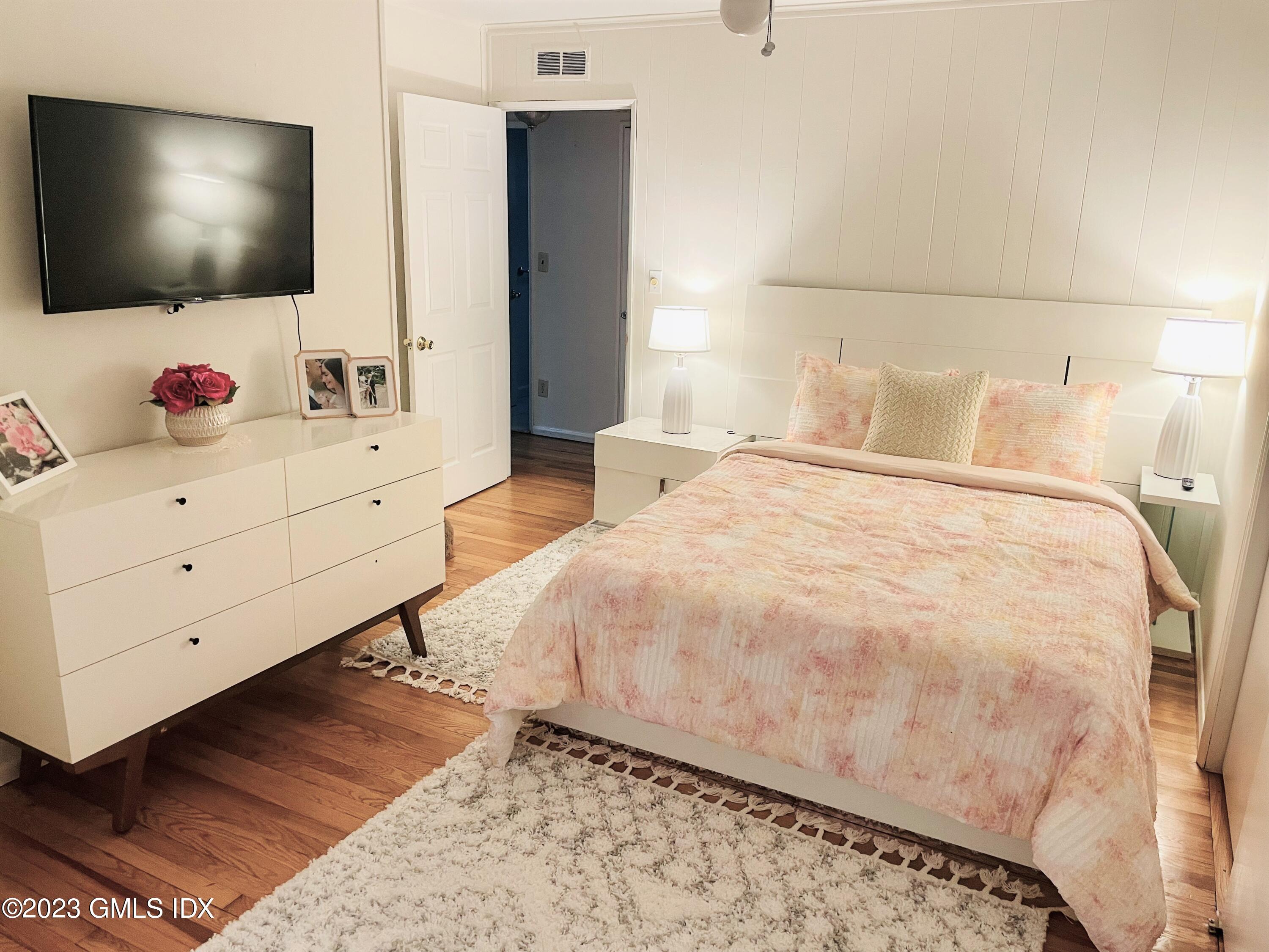 36 Morningside Drive Greenwich, CT 06830 - Photo 8 of 10 a bedroom with a bed and a flat screen tv