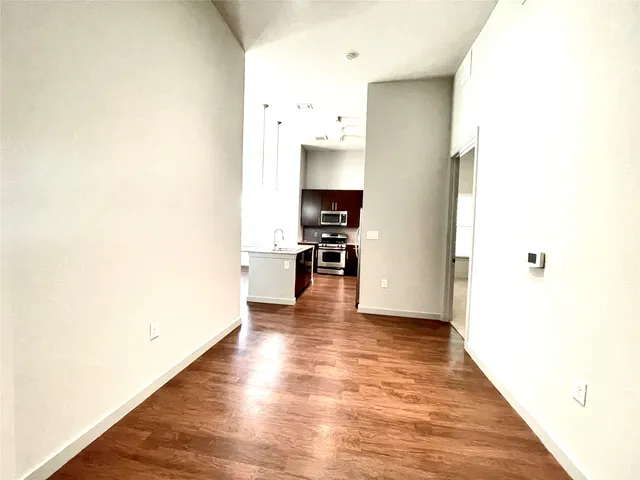 a view of a kitchen with wooden floor