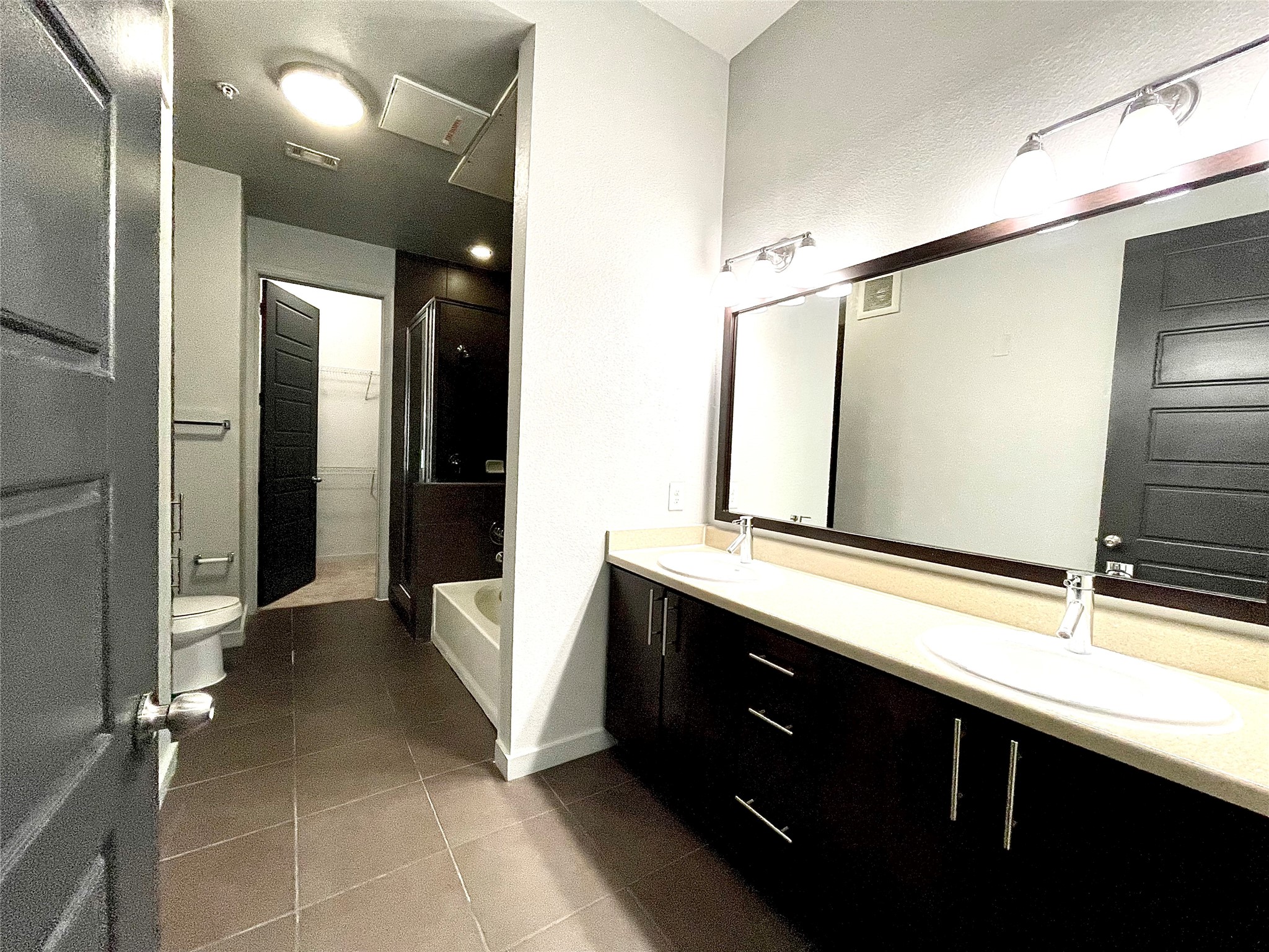 2525 McCue Road, Unit 327 Houston, TX 77056 - Photo 9 of 9 a bathroom with a double vanity sink and a mirror