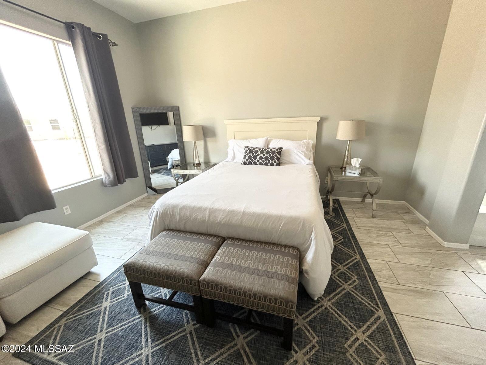 195 Ver Patria Rio Rico, AZ 85648 - Photo 6 of 17 a bedroom with a bed and wooden floor