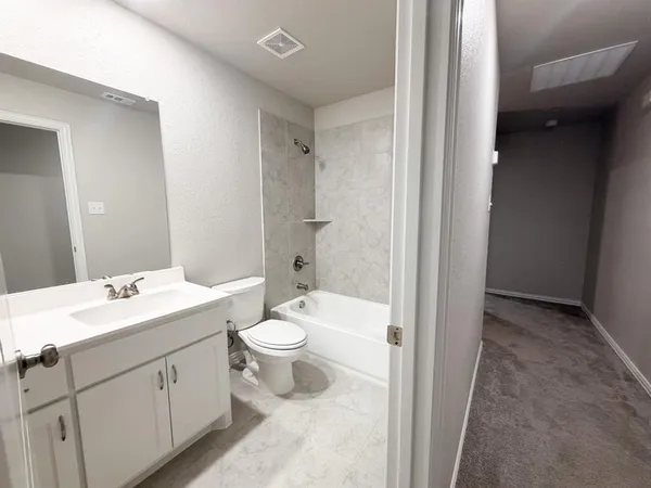 a bathroom with a toilet a sink and a mirror