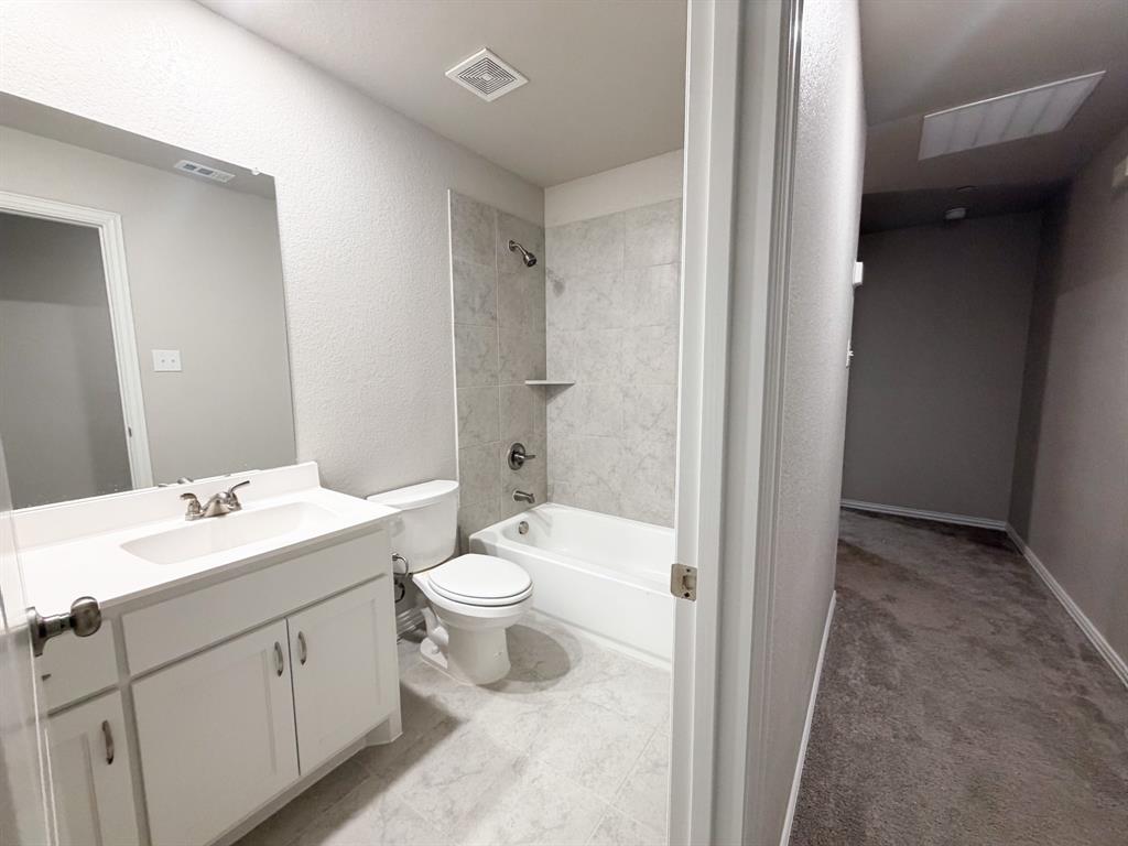 432 Restoration Road Waxahachie, TX 75165 - Photo 17 of 20 a bathroom with a toilet a sink and a mirror