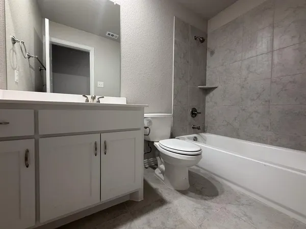 a bathroom with a toilet a sink and bathtub