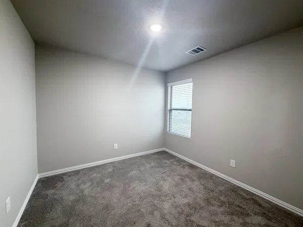 an empty room with a empty space and windows