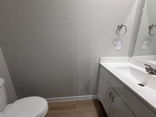 a bathroom with a sink a toilet and vanity