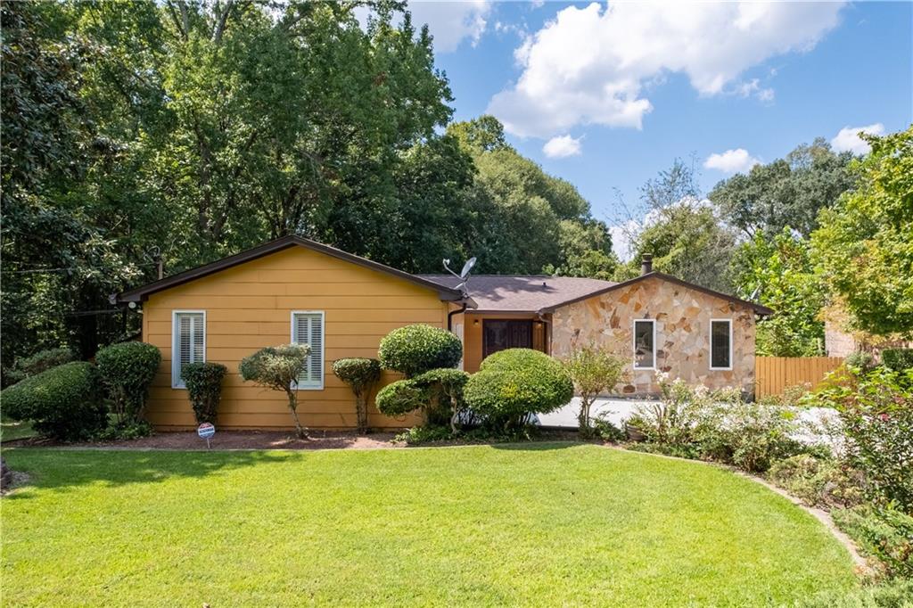 a view of backyard of house with green space