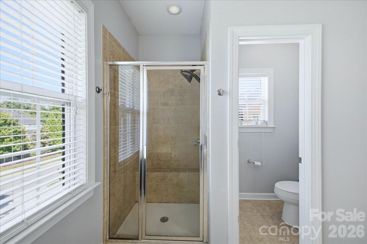 1825 Laveta Road Charlotte, NC 28269 - Photo 22 of 48 a bathroom with a glass shower door