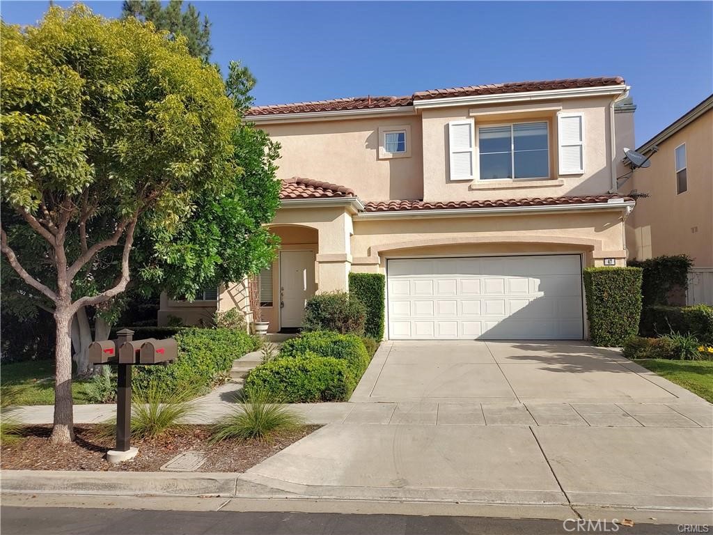 47 Straw Flower Irvine, CA 92620 - Photo 1 of 16 a front view of a house with garden