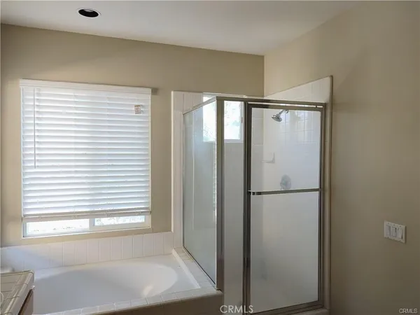 a bathroom with a bathtub and a window