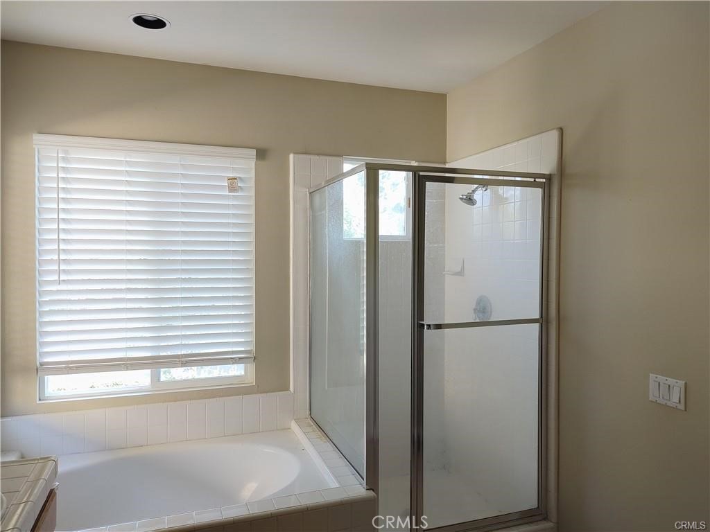 47 Straw Flower Irvine, CA 92620 - Photo 13 of 16 a bathroom with a bathtub and a window