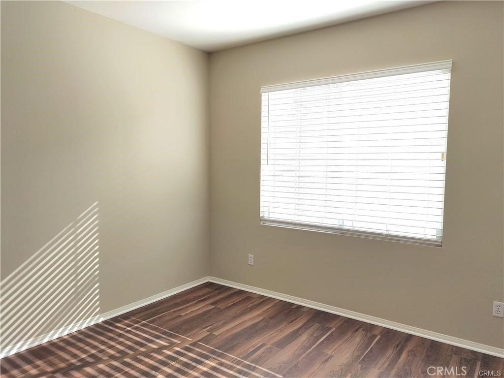 47 Straw Flower Irvine, CA 92620 - Photo 14 of 16 a view of an empty room with wooden floor and a window