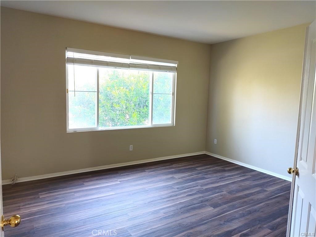 47 Straw Flower Irvine, CA 92620 - Photo 10 of 16 a view of an empty room with wooden floor and a window