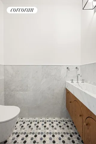 a bathroom with a sink a toilet and a mirror