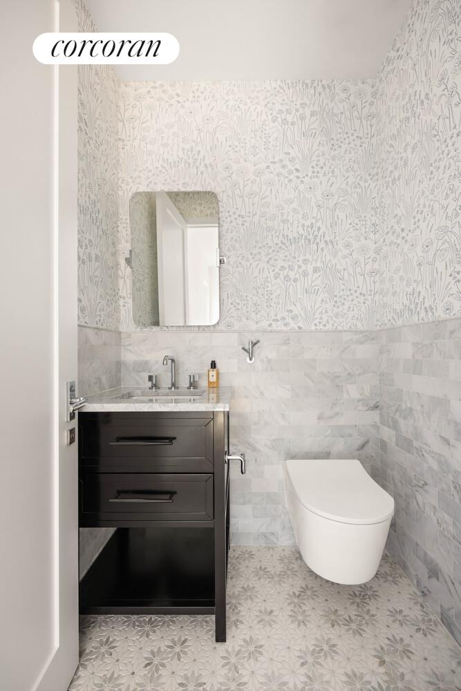 292 Gates Avenue Brooklyn, NY 11216 - Photo 19 of 25 a bathroom with a sink and a mirror