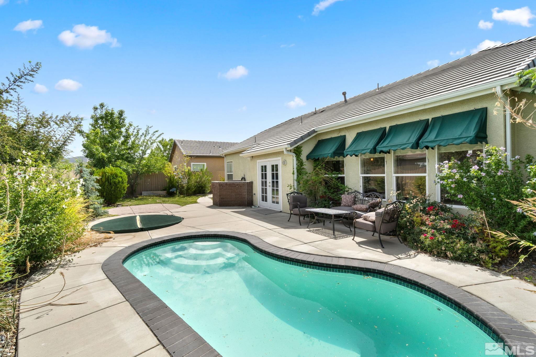 9607 Glen Ridge Drive Reno, NV 89521 - Photo 3 of 22 a view of swimming pool with outdoor seating and plants