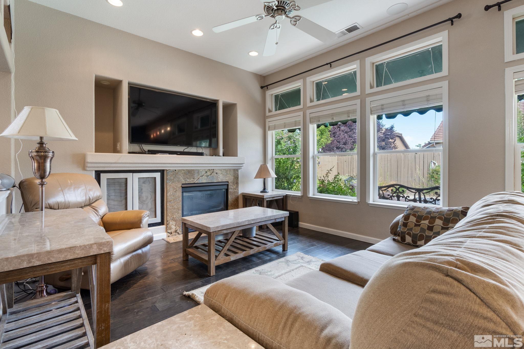 9607 Glen Ridge Drive Reno, NV 89521 - Photo 5 of 22 a living room with furniture a flat screen tv and a fireplace