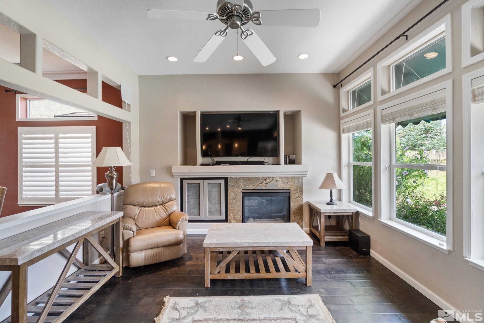 9607 Glen Ridge Drive Reno, NV 89521 - Photo 6 of 22 a living room with furniture a flat screen tv and a fireplace