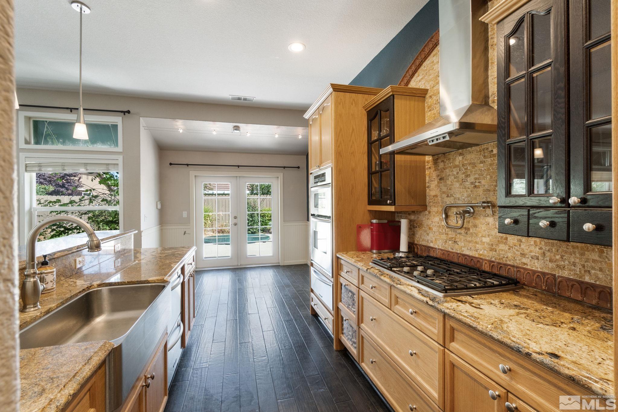 9607 Glen Ridge Drive Reno, NV 89521 - Photo 8 of 22 a kitchen with stainless steel appliances granite countertop a stove and a sink