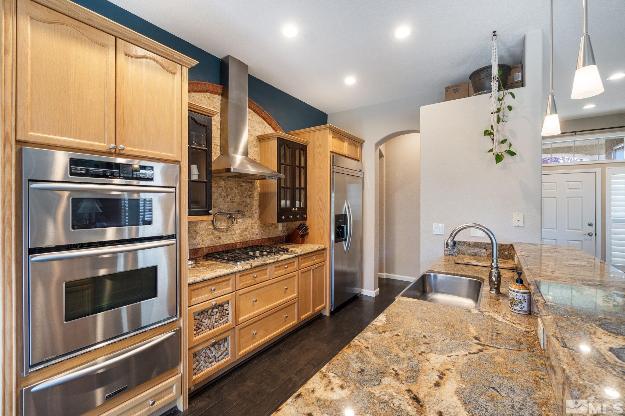 9607 Glen Ridge Drive Reno, NV 89521 - Photo 9 of 22 a kitchen with stainless steel appliances granite countertop a stove a sink and a refrigerator