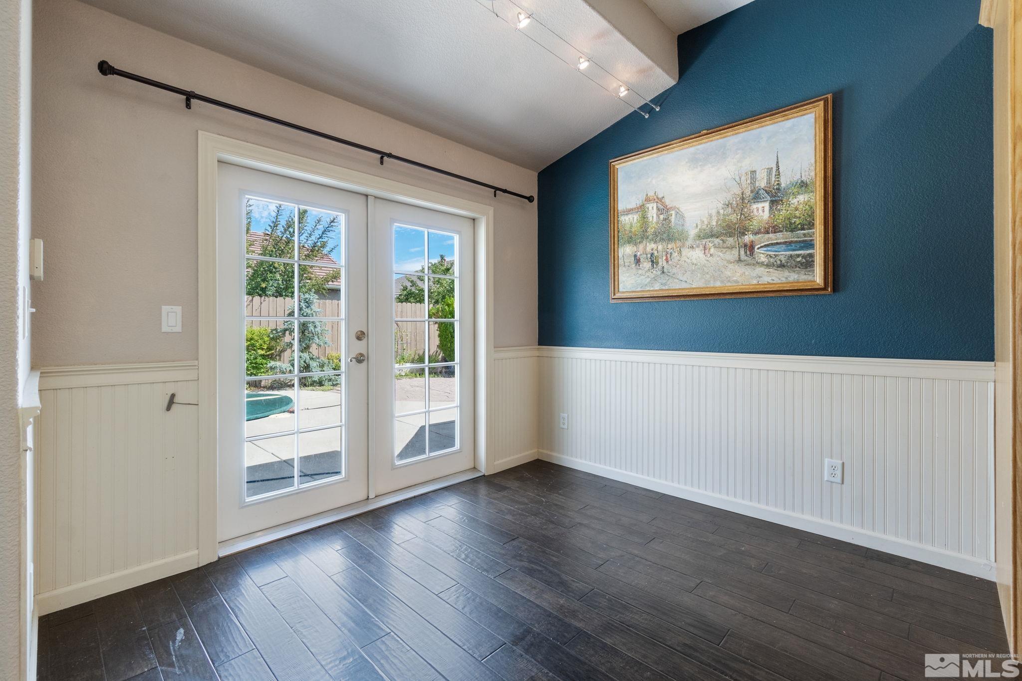 9607 Glen Ridge Drive Reno, NV 89521 - Photo 10 of 22 a view of an empty room with wooden floor and a window