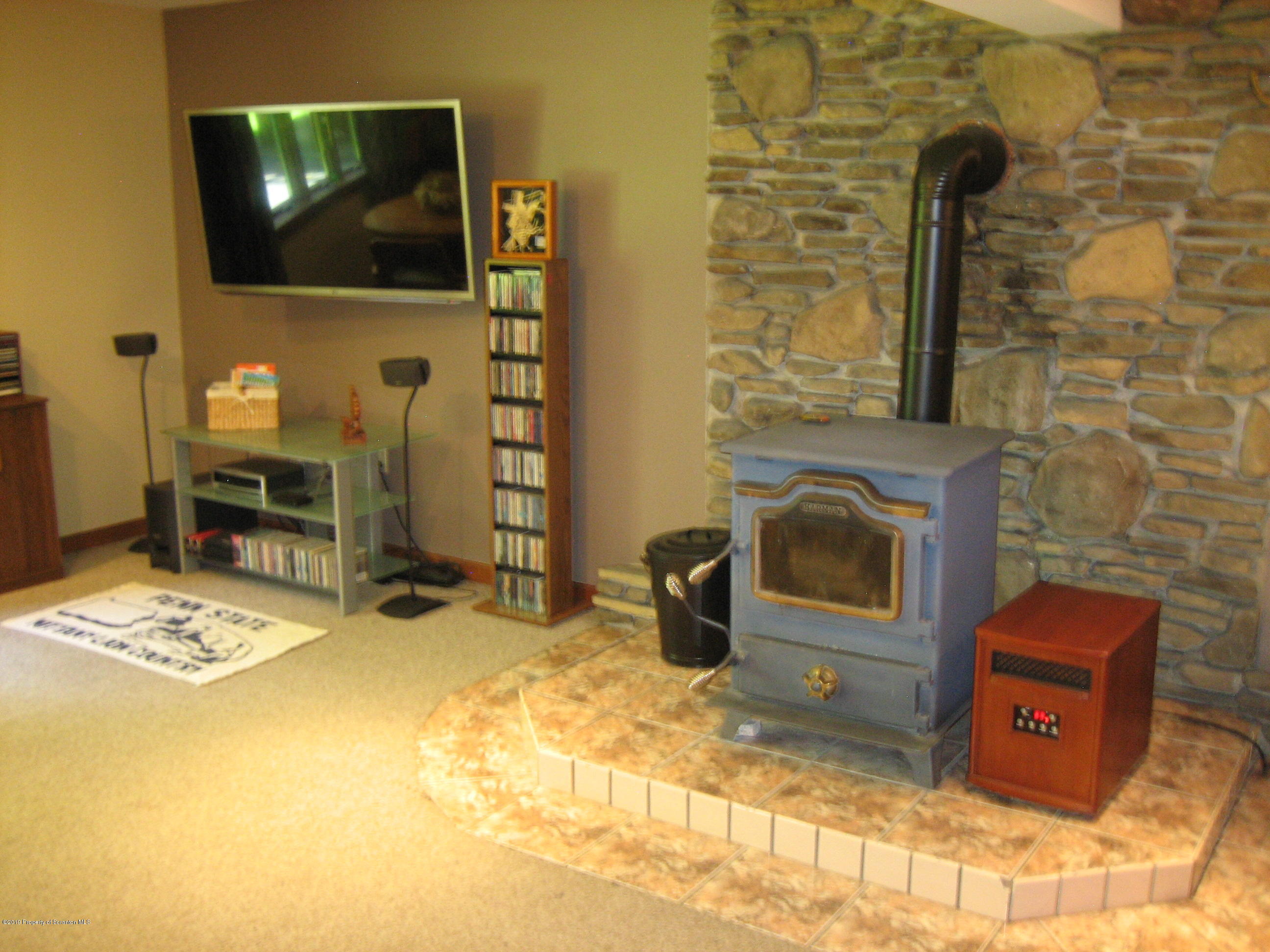78 D Aberdeen Road Moscow, PA 18444 - Photo 31 of 70 a living room with fireplace furniture and a flat screen tv