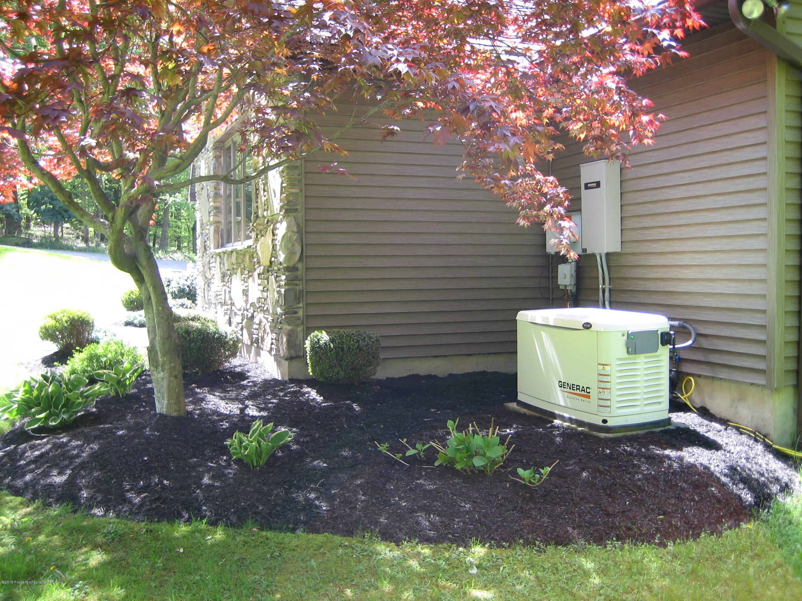 78 D Aberdeen Road Moscow, PA 18444 - Photo 59 of 70 a view of a backyard with plants and white chairs
