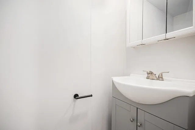 a bathroom with a sink and mirror