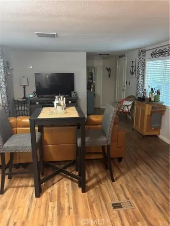 a room with furniture a flat screen tv and a table