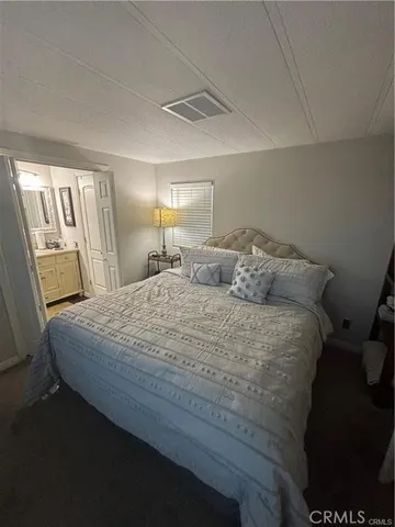 a bedroom with a bed and a mirror