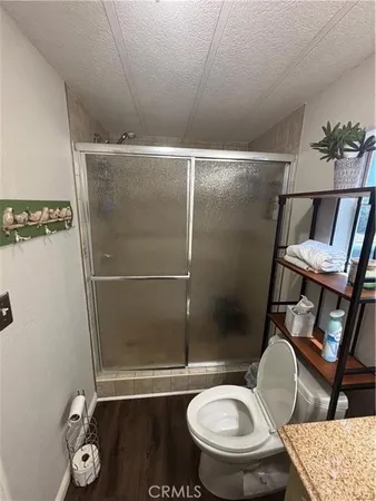 a bathroom with a toilet and a shower