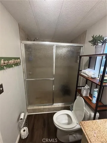 a bathroom with a toilet and a shower