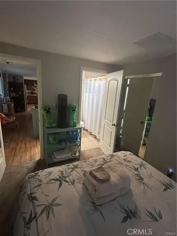 a bedroom with a bed and flat screen tv