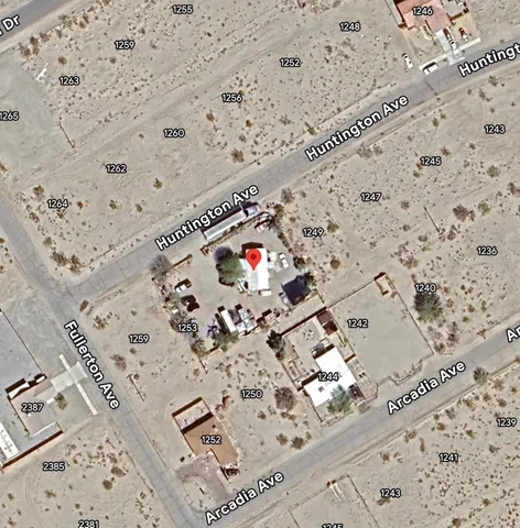 a street sign on a wall next to a road