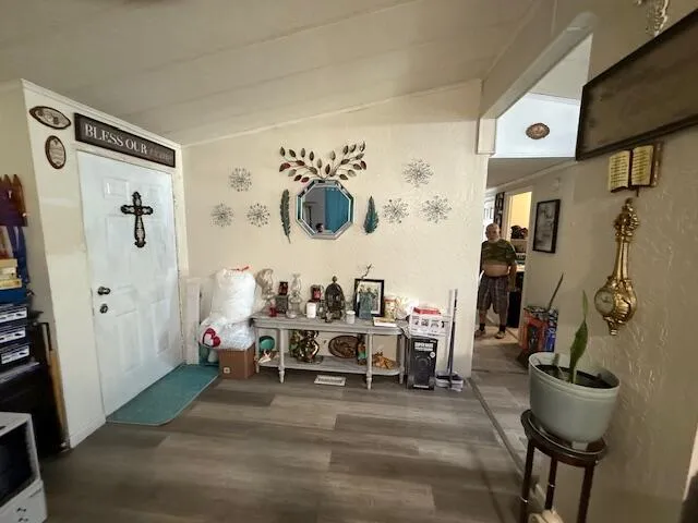 a living room with furniture a flat screen tv and a large window