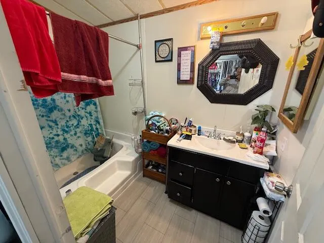 a bedroom with a bed and a mirror