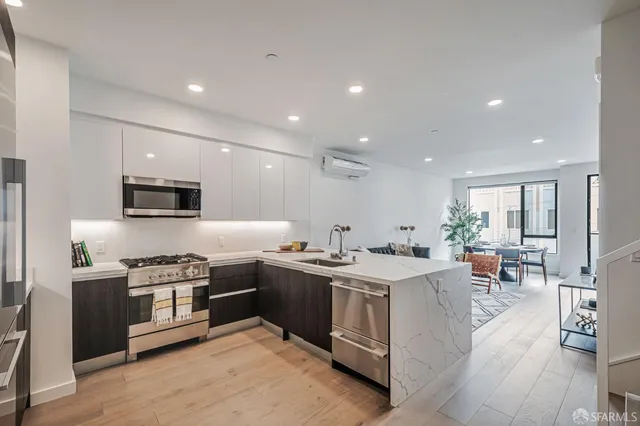 a kitchen with stainless steel appliances granite countertop a stove and a sink