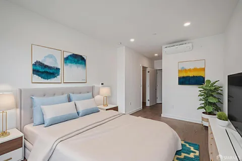 a bedroom with a bed and a painting on the wall