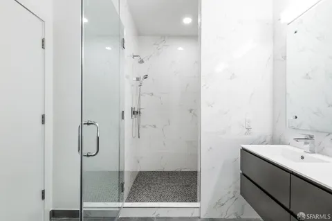 a bathroom with a shower and sink