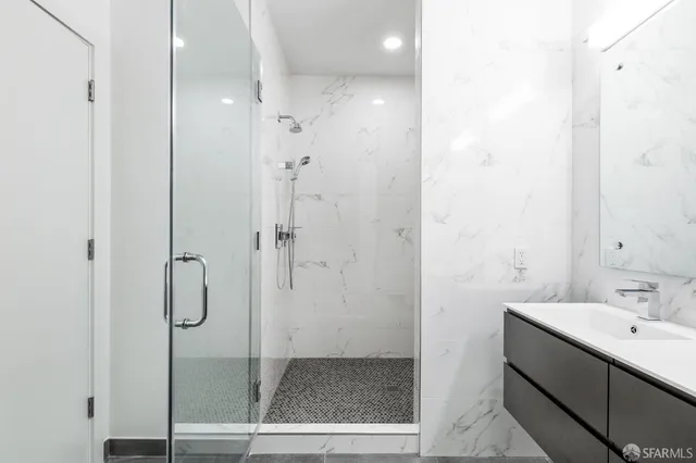 a bathroom with a shower and sink