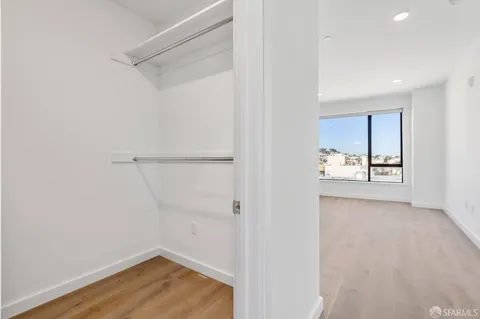 a view of a room with wooden floor and cabinet