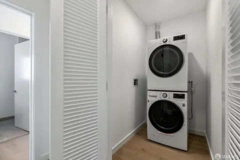 a view of a hallway with a washer and dryer