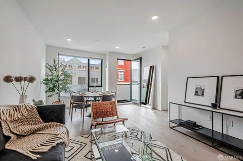 a living room with furniture a rug and a window