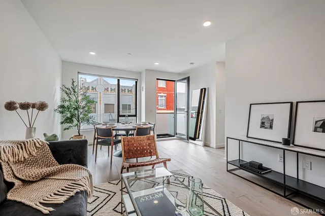 a living room with furniture a rug and a window