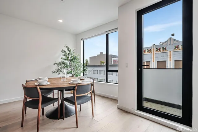 a view of a dining room with furniture window and wooden floor