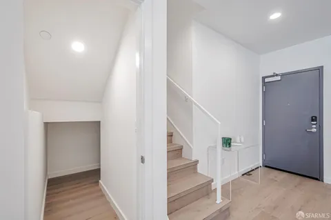 a view of entryway with furniture and wooden floor